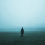 person standing on misty ground
