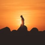 person standing on rock platform