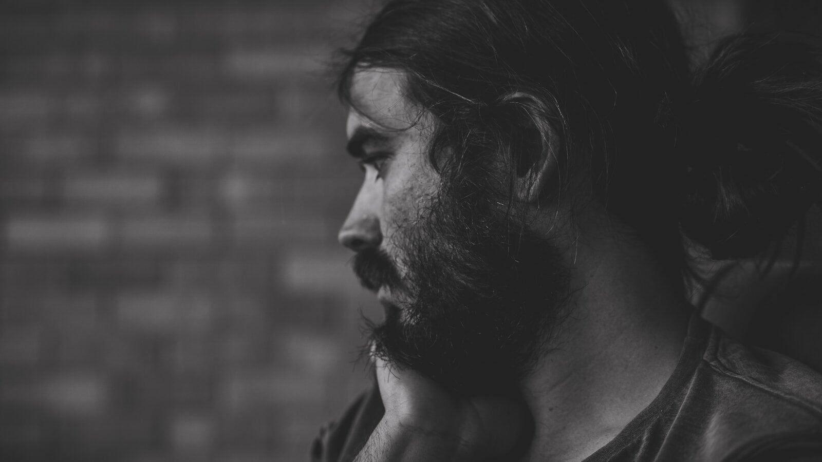 Man with beard and long hair looking away
