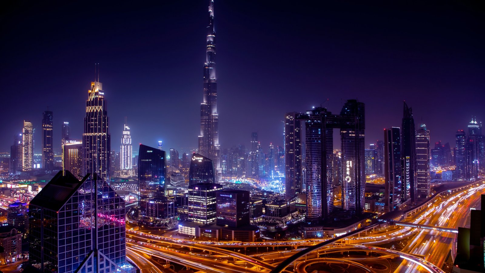 Dubai skyline at night with illuminated city buildings