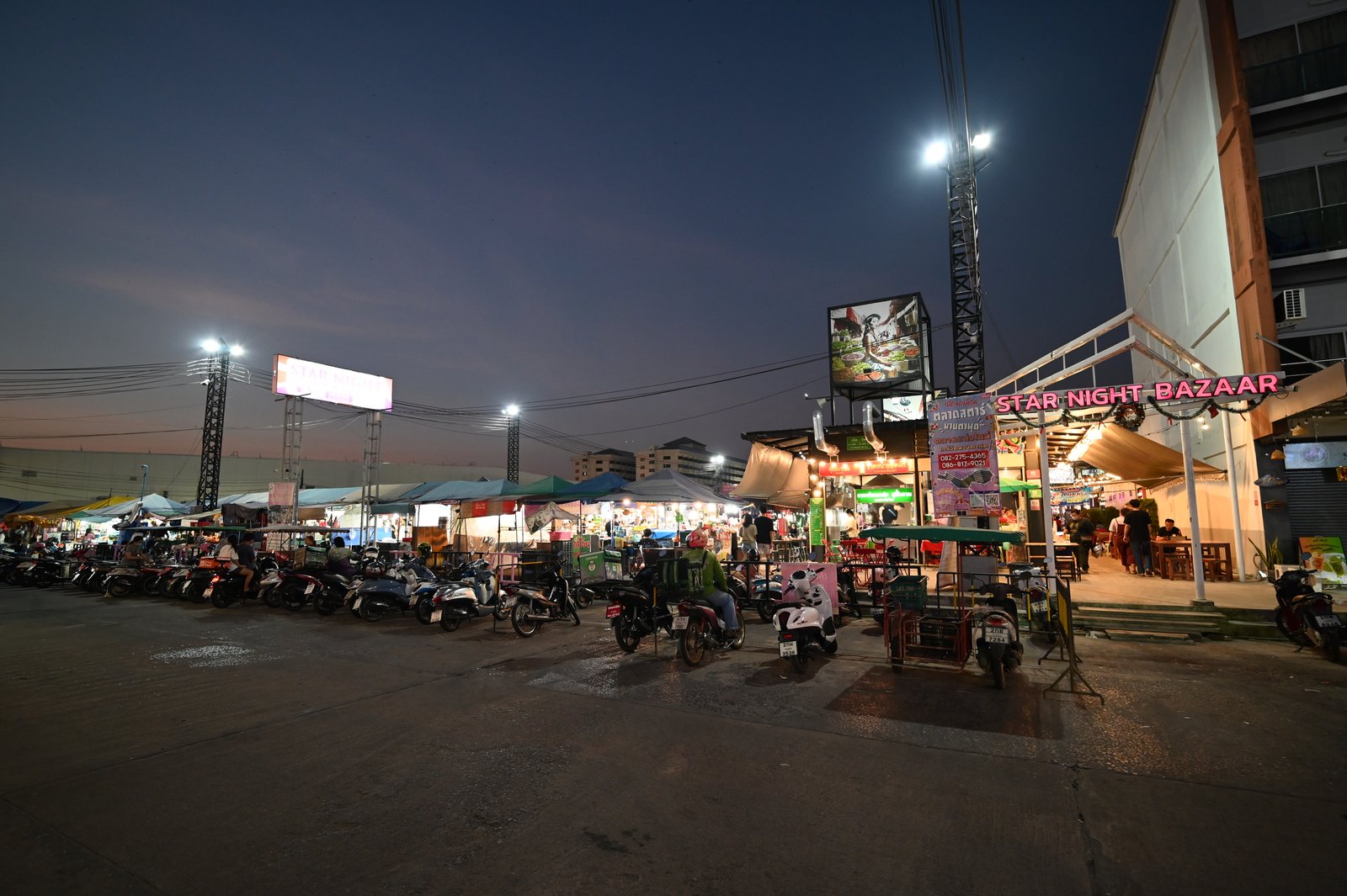 Busy Asian night market with food stalls after dark